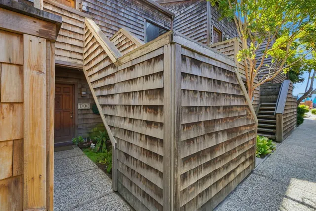 a view of backyard with wooden house and wooden floor