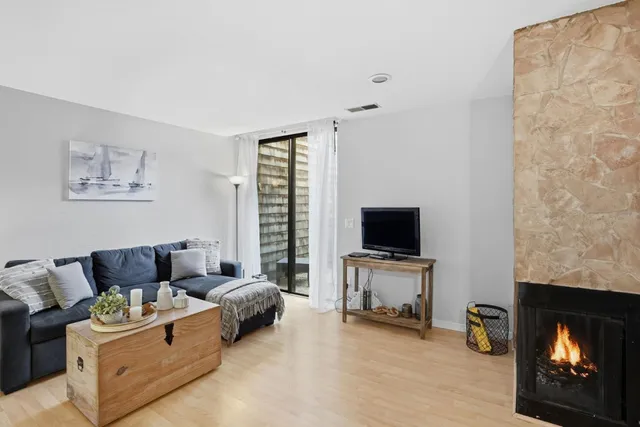 a living room with furniture and painting on the wall