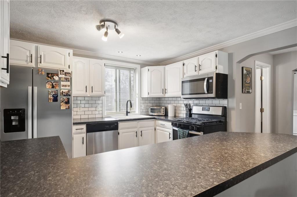 431 Thompson Run Road Pittsburgh, PA 15237 - Photo 7 of 27 a large kitchen with cabinets and stainless steel appliances