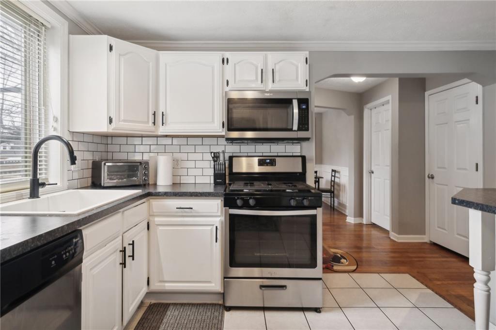 431 Thompson Run Road Pittsburgh, PA 15237 - Photo 9 of 27 a kitchen with cabinets stainless steel appliances a sink and a stove