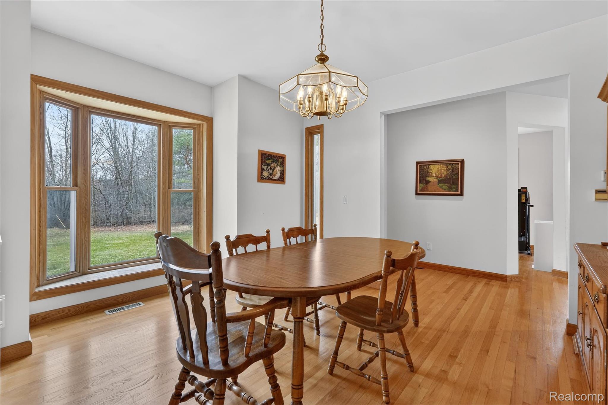 5640 Fisher Road Howell, MI 48855 - Photo 9 of 66 Dining area featuring hanging lights and light wood-style flooring