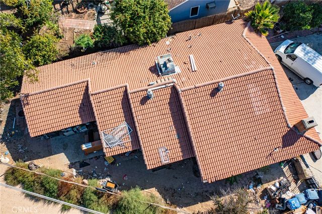 an aerial view of a house with a yard