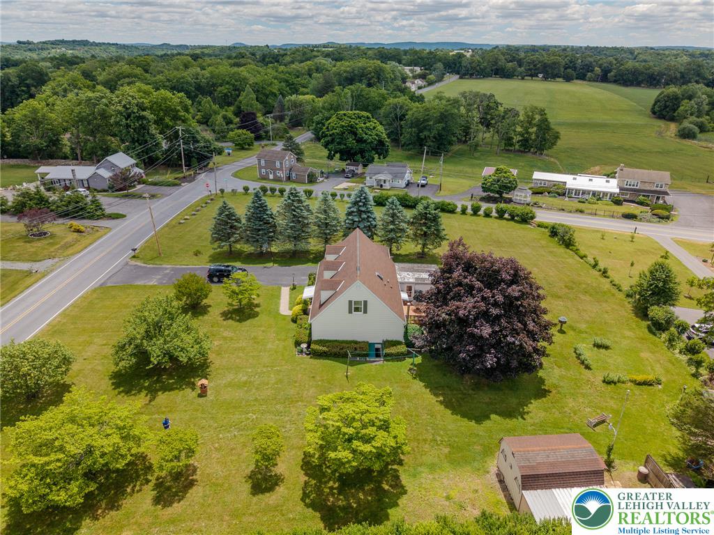 40 Locke Heights Road Bangor, PA 18013 - Photo 8 of 28 An aerial perspective reveals a serene countryside setting with verdant fields and mature trees.