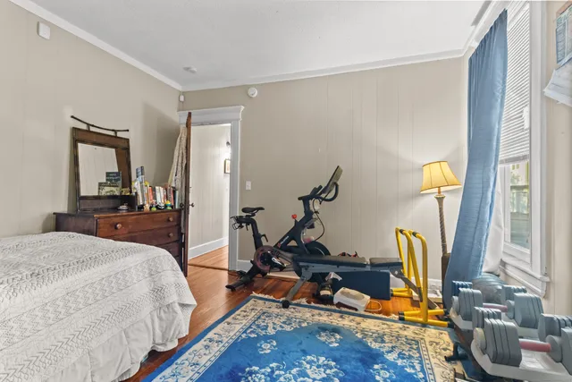 a bed room with a bed and gym equipment