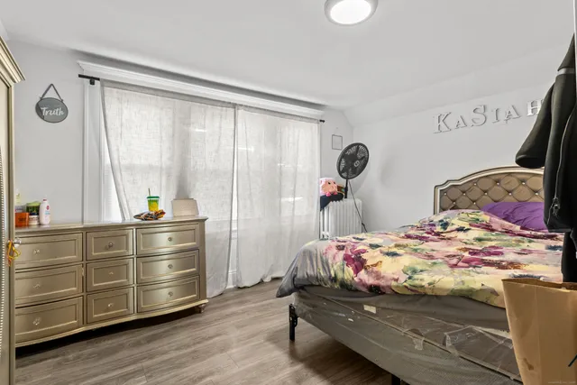 a bedroom with a bed and a window