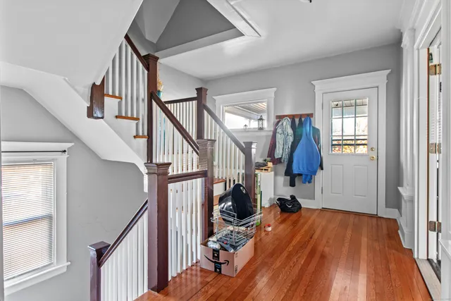 a view of entryway with wooden floor and stairs