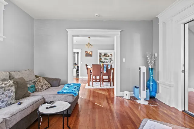 a living room with furniture a rug and a table