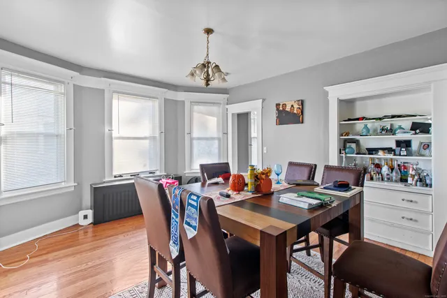 a view of a dining room with furniture window and wooden floor