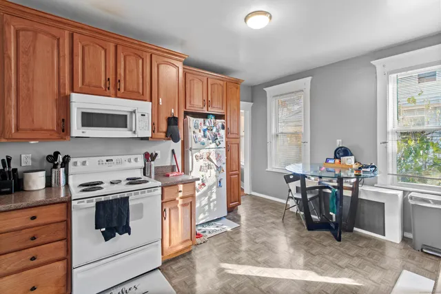a kitchen with stainless steel appliances a stove a sink cabinets and a window
