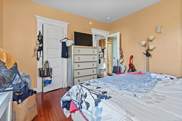 a bedroom with a bed and dresser