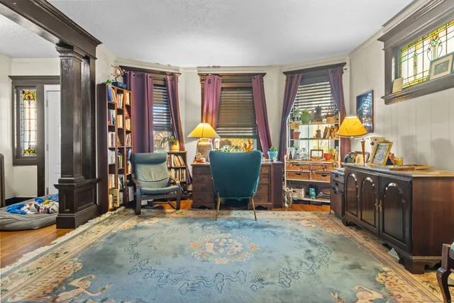 a view of a workspace with furniture and a window