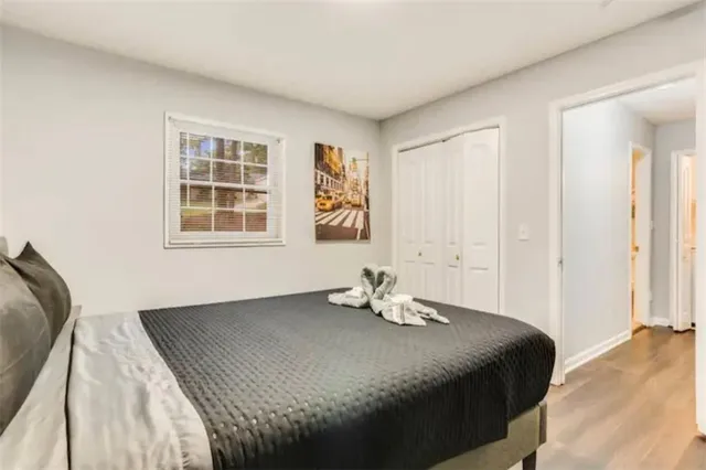 a bedroom with a bed and wooden floor