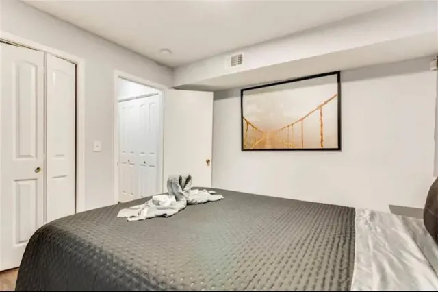 a view of a bedroom with a bed and a window