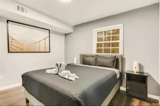 a bedroom with a bed and a wall painting