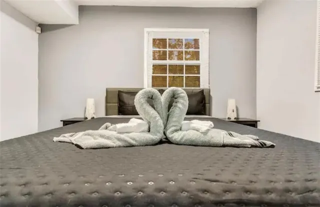 a bedroom with a bed and a window