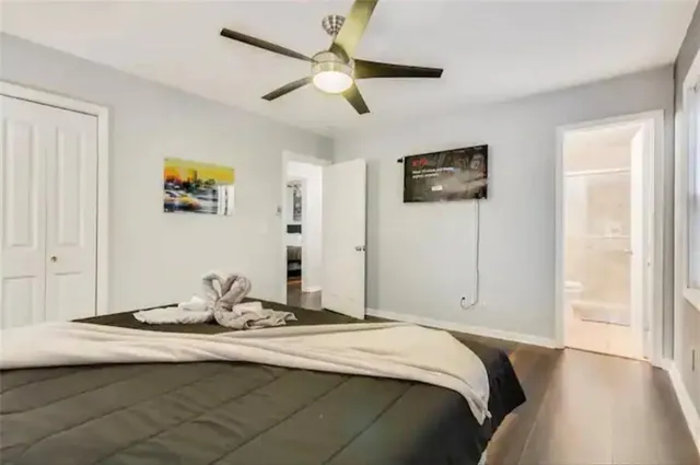 a view of a bedroom with wooden floor