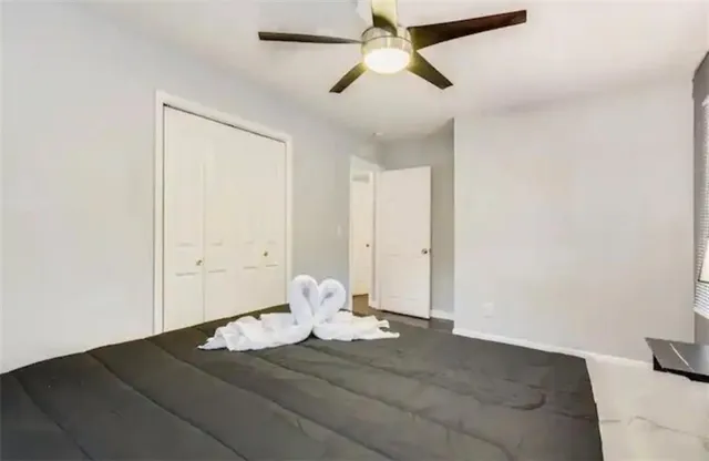 a bedroom with a bed and a painting on the wall