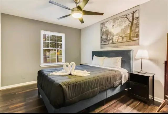 a bedroom with a bed and wooden floor