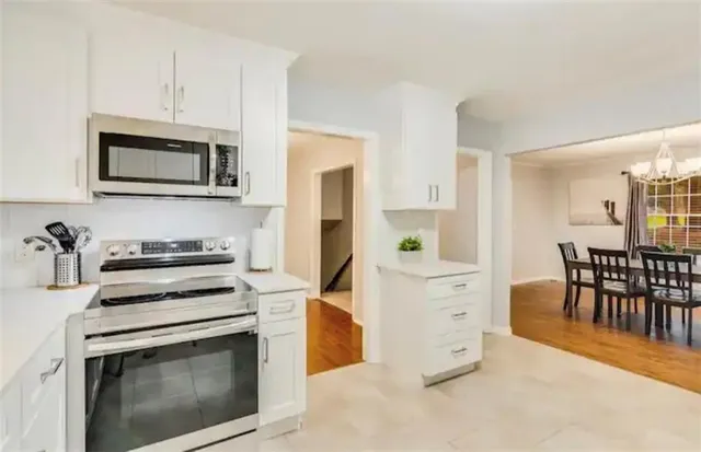 a bathroom with a toilet a sink a mirror and a window