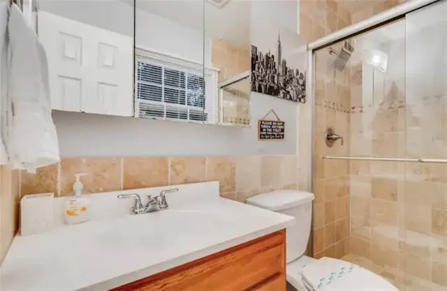 a backyard of a house with barbeque oven table and chairs