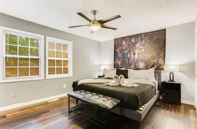 a view of a patio with couches table and chairs and wooden floor