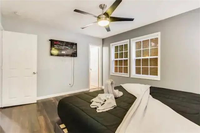 a view of a house with a big yard and large trees