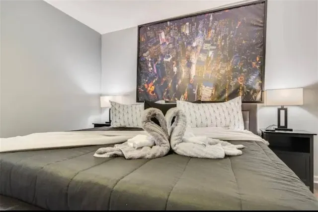 a bedroom with a bed a table and a window