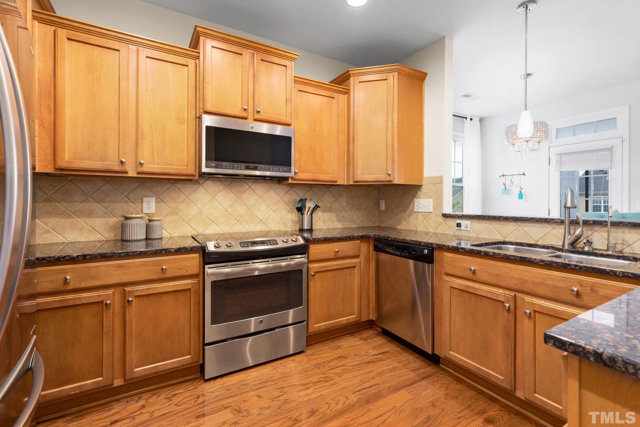 10115 Glen Autumn Road Raleigh, NC 27617 - Photo 11 of 55 EZ Kitchen is centrally located between the formal dining room in the front of the home, and opens to the rear breakfast area & family room for convenience and additional seating.