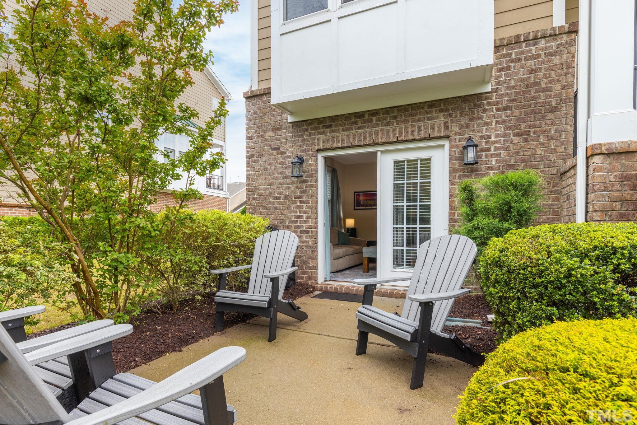10115 Glen Autumn Road Raleigh, NC 27617 - Photo 34 of 55 Front courtyard patio surrounded by lush landscaping for privacy.