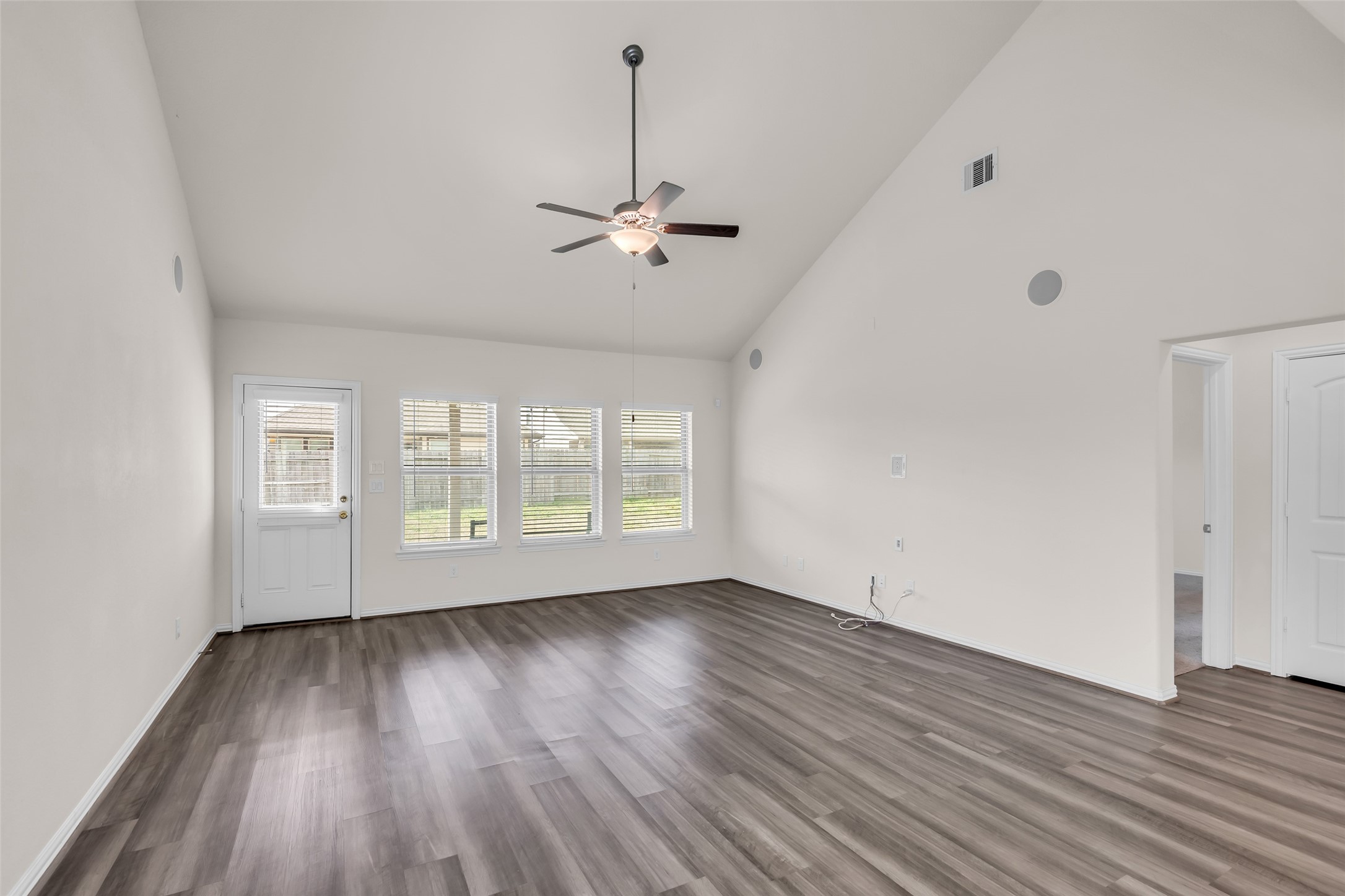 28130 Aspen Horizon Drive Spring, TX 77386 - Photo 15 of 39 an empty room with wooden floor chandelier fan and windows