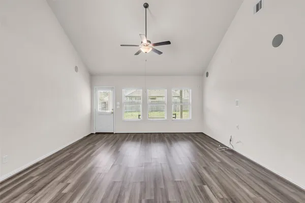 wooden floor in an empty room with a window