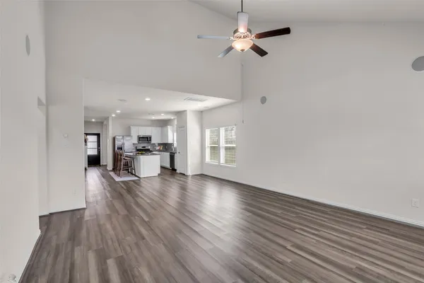 a view of empty room with wooden floor