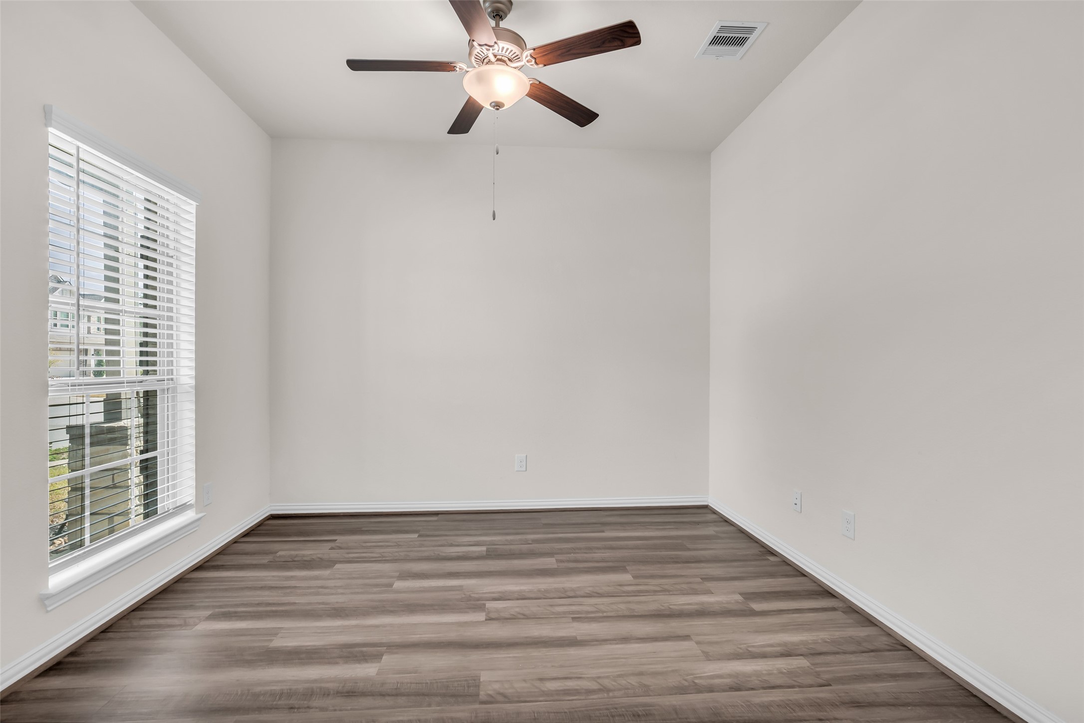 28130 Aspen Horizon Drive Spring, TX 77386 - Photo 3 of 39 a view of an empty room with wooden floor and a window