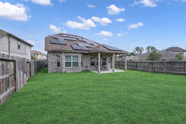 a view of a house with a backyard