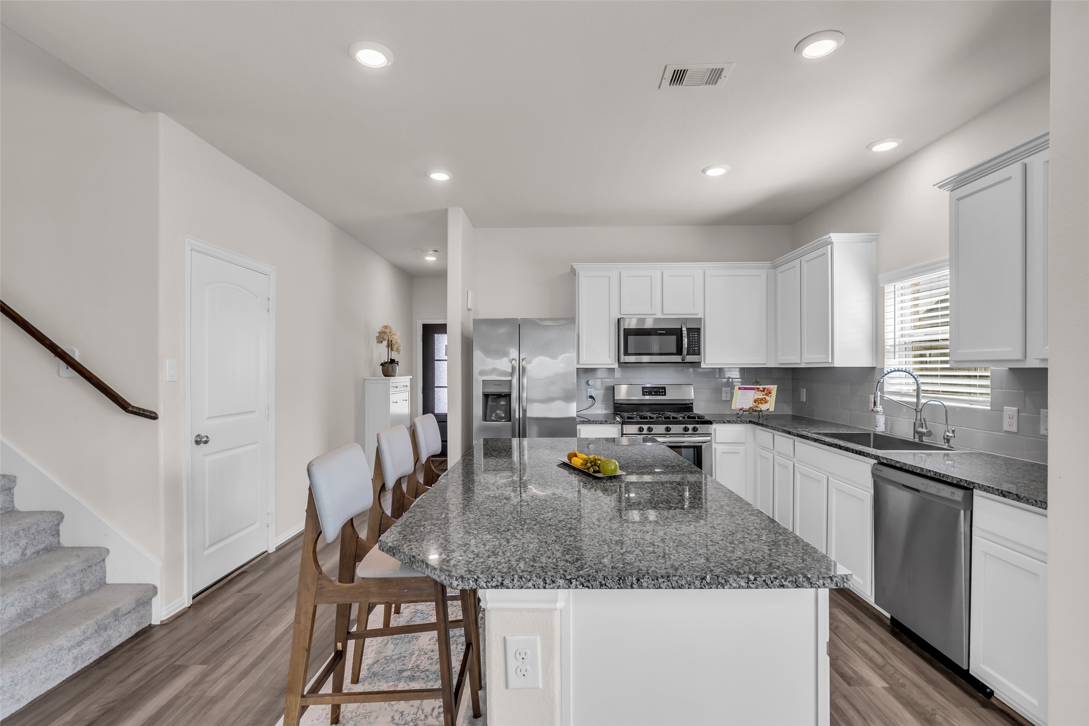 28130 Aspen Horizon Drive Spring, TX 77386 - Photo 6 of 39 a kitchen with a sink a counter space appliances and cabinets