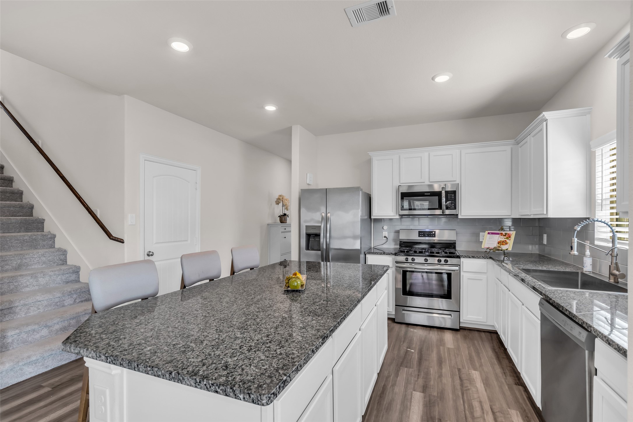 28130 Aspen Horizon Drive Spring, TX 77386 - Photo 7 of 39 a kitchen with stainless steel appliances granite countertop a stove top oven a sink dishwasher a refrigerator and cabinets with wooden floor