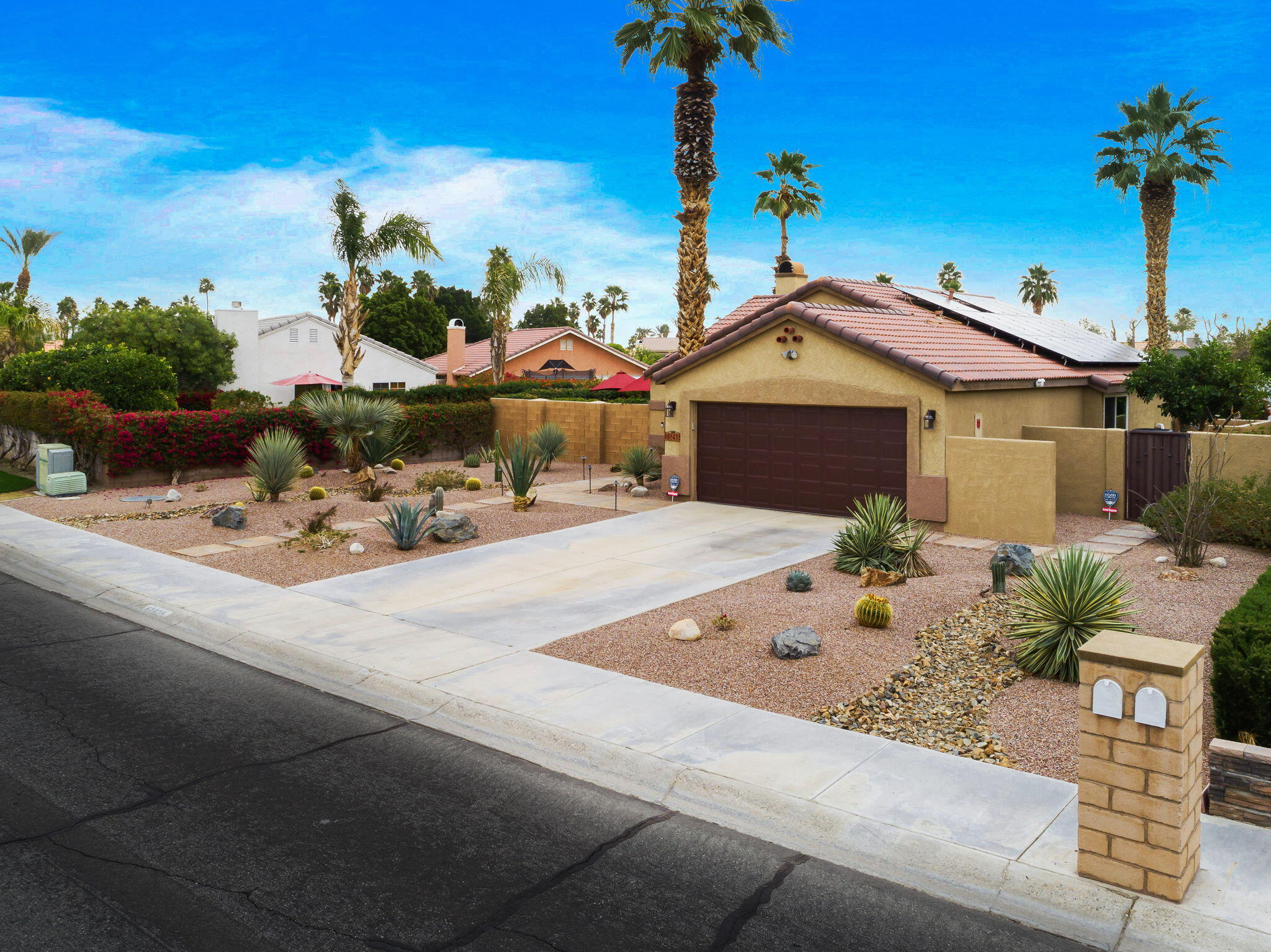 68435 Durango Road Cathedral City, CA 92234 - Photo 3 of 41 a front view of a house with a garden