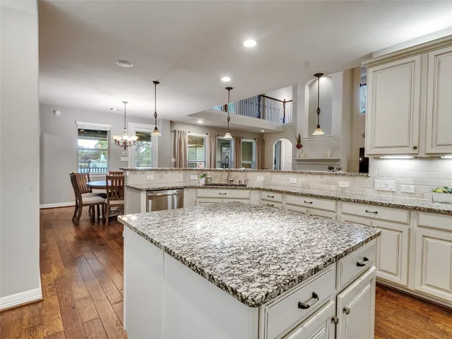 a kitchen with kitchen island granite counter and a sink