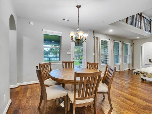 a view of a dining room with furniture and chandelier