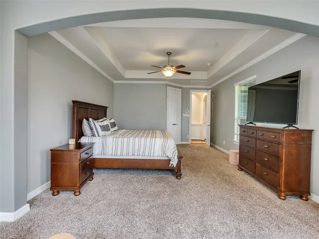a bedroom with furniture and a flat screen tv