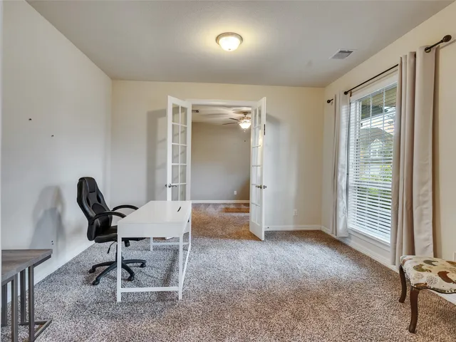 a view of a workspace with furniture and windows