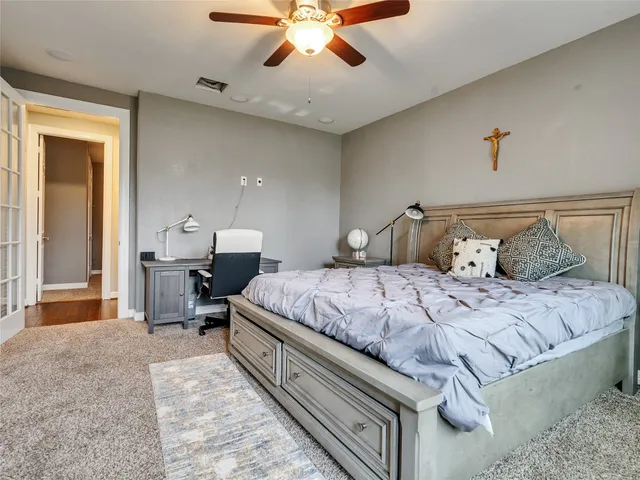 a bedroom with a bed and a chandelier