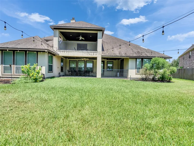 a front view of a house with a yard and plants