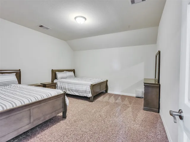 a bathroom with a granite countertop sink and a toilet