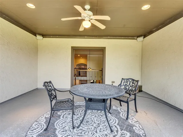 a dining room with furniture and a floor to ceiling window