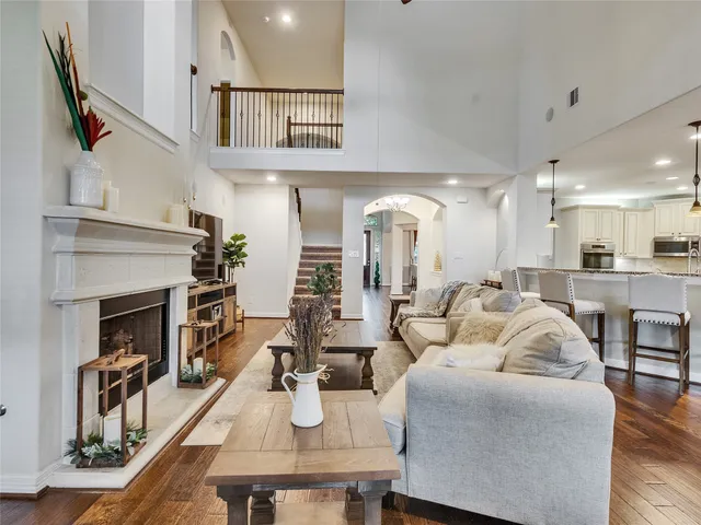 a living room with furniture fireplace and kitchen view