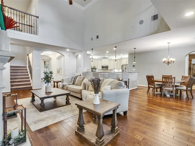 a living room with furniture kitchen view and a dining table