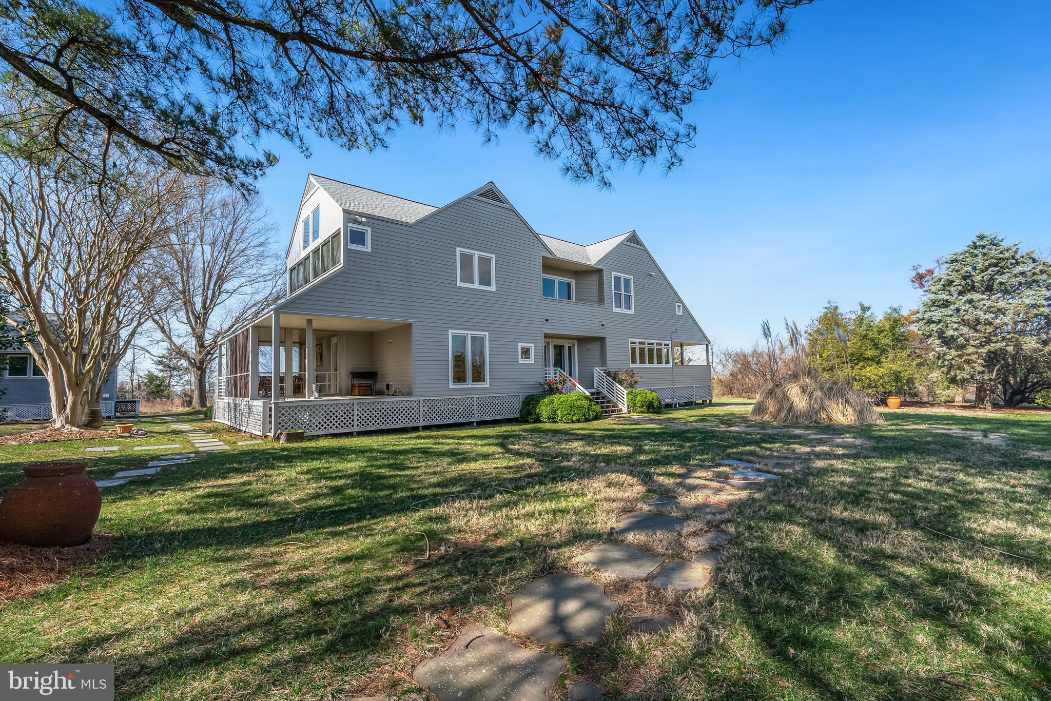 26319 Chanticleer Road Oxford, MD 21654 - Photo 14 of 55 a front view of a house with a yard