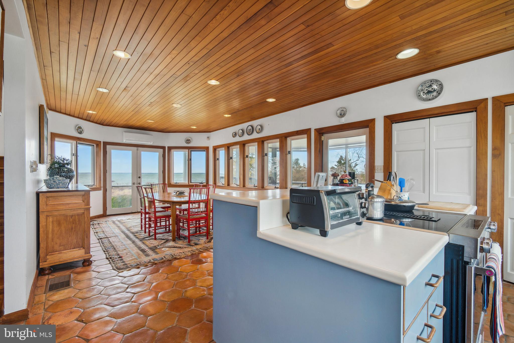 26319 Chanticleer Road Oxford, MD 21654 - Photo 23 of 55 a dining hall with couches a barbecue dining table and chairs with outer view