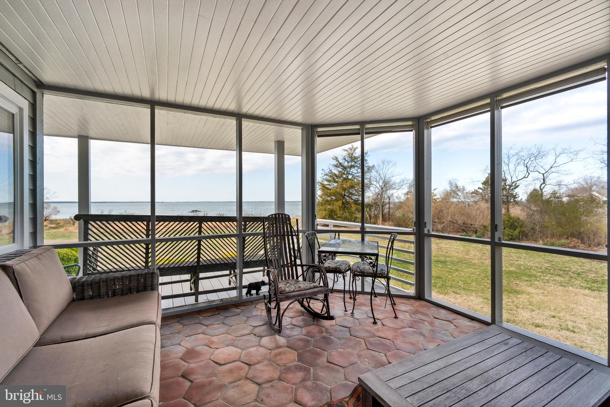 26319 Chanticleer Road Oxford, MD 21654 - Photo 25 of 55 a living room with furniture and a floor to ceiling window